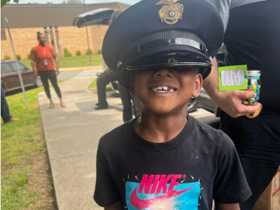 student wears police hat