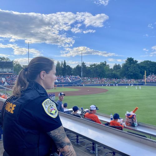 Officers stands at her post during a baseball game